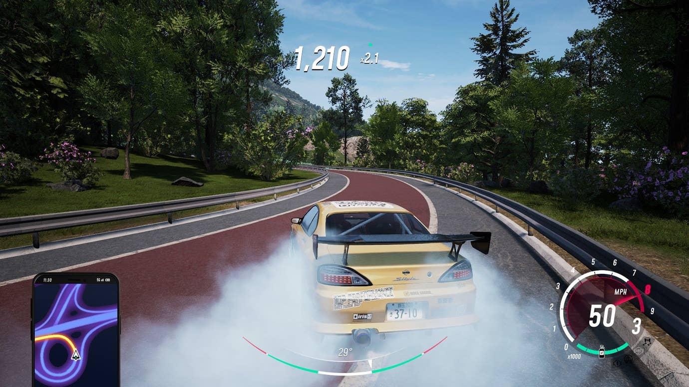 Smoke billows from the back tires of a car with a spoiler on a training course.